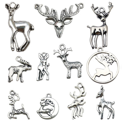 Antique silver reindeer charms arranged on a light background