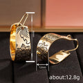 Gold Tone Wide Hoop Earrings With Black Floral Line Art view 4