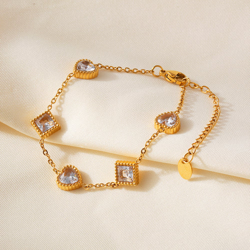 Gold clear zircon heart square station bracelet on cream fabric