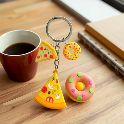 Front display of ten food and sports PVC keychains with visible colors and attached hardware