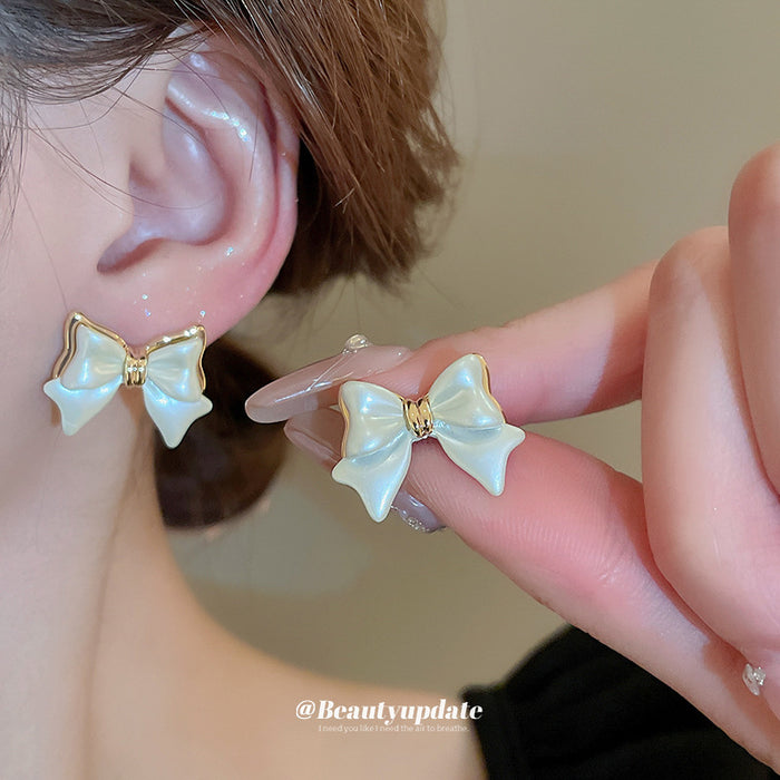 White Enamel Bow Stud Earrings With Gold Tone Edges
