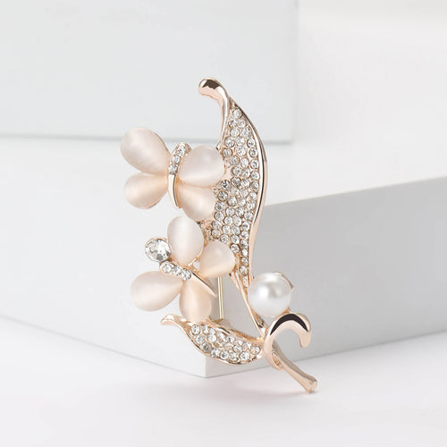 Front view of the pearl floral spray brooch and its color options