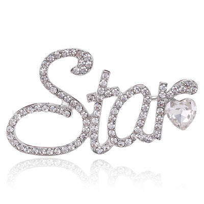 Front view of the crystal star script brooch in gold or silver tone with polished metal detail on a white background