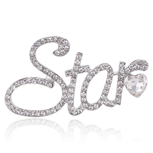 Front view of the crystal star script brooch in gold or silver tone with polished metal detail on a white background