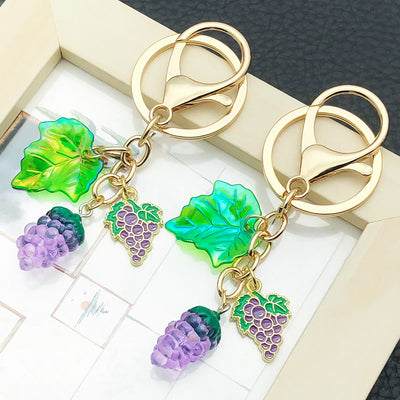 Front display of purple grape cluster keychain with leaf and mini charm with visible colors and attached hardware