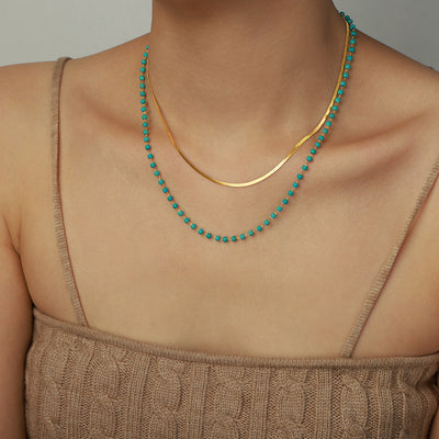 Double layer turquoise bead and gold snake chain worn