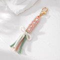 Gold Tone Woven Daisy Bow Tassel Clip Keychains in Four Colors view 2