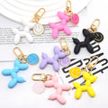 Gold Tone Balloon Dog and Smile Disc Clip Keychains view 1