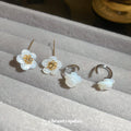 White Flower Hook Earrings in Silver and Gold with Polished Metal Details view 4