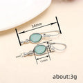 Silver Tone Oval Drop Earrings with Pale Green Centers view 4