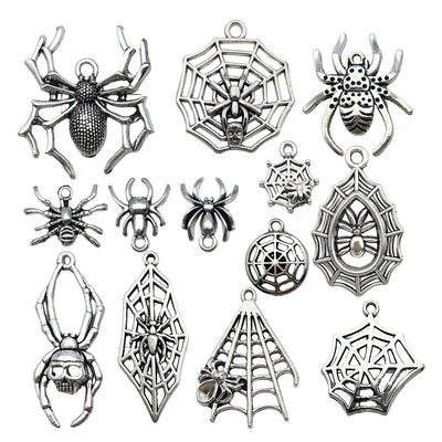 Antique silver bat charms arranged on a light background