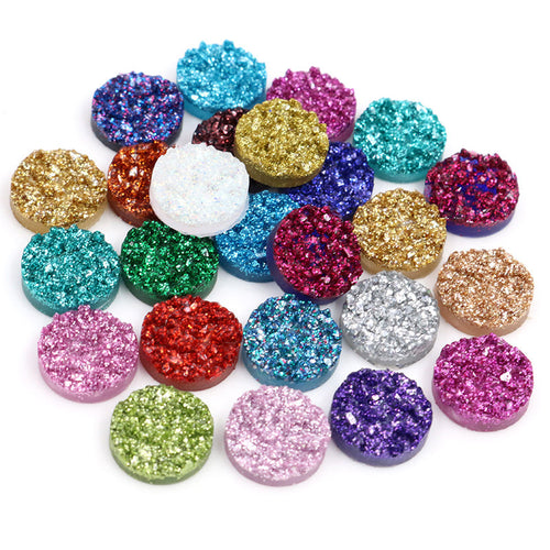 Glitter resin cabochons showing assorted shapes and finishes