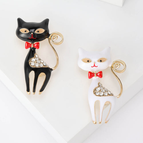 Front view of the bow tie cat crystal brooch in black and white enamel brooch and its color options