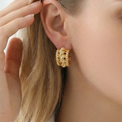 On-ear view of twisted link C hoop stud earrings in main image 2.