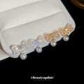 Crystal Bow Pearl Drop Stud Earrings In Gold And Silver view 2
