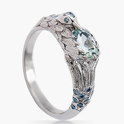 White gold hummingbird ring pale aqua center blue accents side view