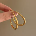 Textured Oval Hoop Earrings in Gold and Silver Tones view 6