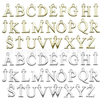 Metallic letter charms arranged on a light background