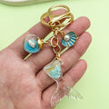 Starfish, Conch and Shell Charm Keychains Featuring Flower Across 31 Pictured Variations view 2