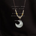 Dark Braided Cord Necklace With White Pearlescent Crescent Pendant view 1