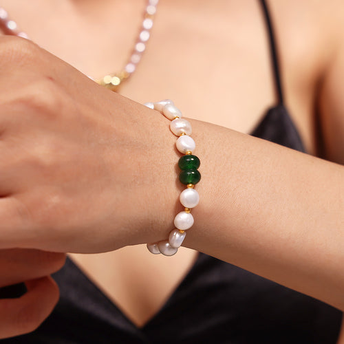Green stone pearl bracelet worn on wrist close-up