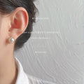 Gold Tone Crossed Circle White Pearl And Clear Stone Stud Earrings view 2