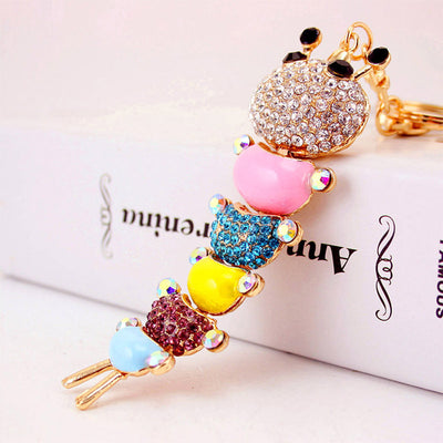 Close-up of a multicolor caterpillar charm with clear, blue, and pink rhinestones.