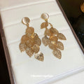 Gold Tone Filigree Leaf Cluster Drop Earrings With Polished Metal Tone Details view 3