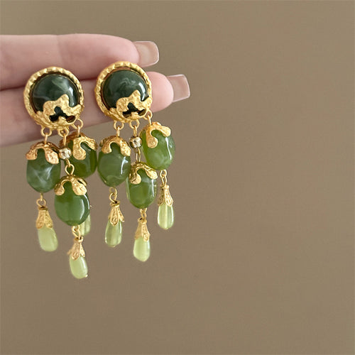 green vintage chandelier earrings displayed from a second angle