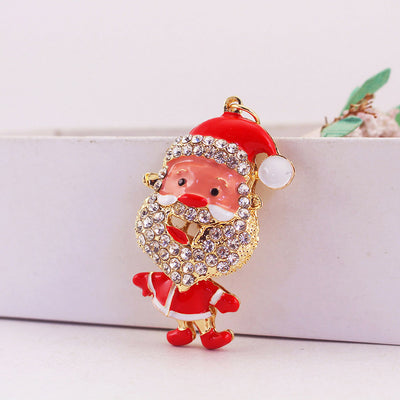 Close-up of the red Santa charm leaning beside a white box.