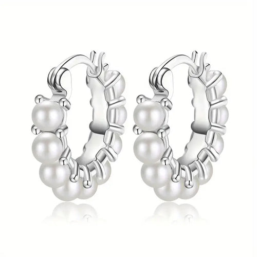 Product view showing small polished hoops decorated with a row of round pearl-like beads