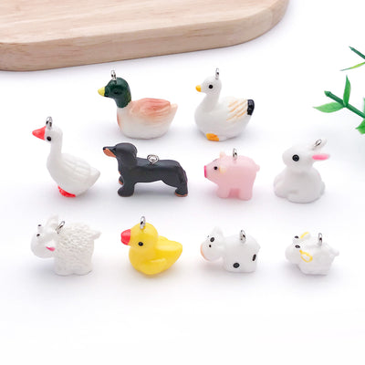 Multicolor dog and rabbit charms arranged on a light background