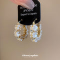 White Flower and Crystal Hoop Earrings in Polished Gold Tone view 2