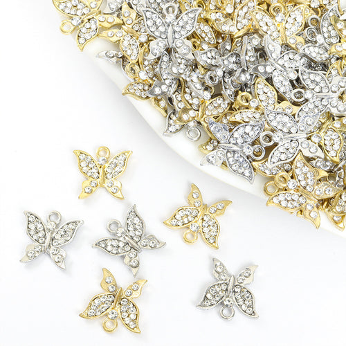 Assorted butterfly silhouette charms arranged beside a tray