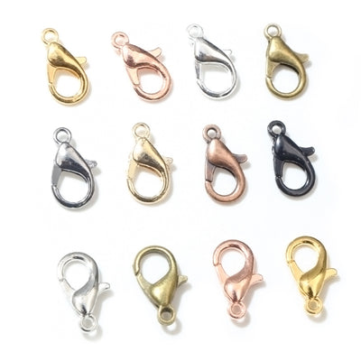 Front overview of small lobster clasps in eight mixed metal finishes arranged on a light background