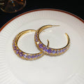 Gold Tone Crescent Hoop Earrings with Purple Crystals view 6