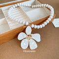 White Beaded Necklace With Large Five Petal Flower Pendant view 4