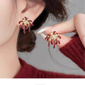 Gold Tone Red Firework Burst Stud Earrings with Clear Crystals view 3