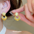 Gold Tone Geometric Drop Earrings With Pale Stone Centers view 2