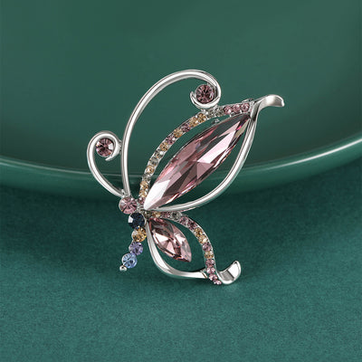 Front view of abstract butterfly brooch with four large marquise crystal wings against a white background.