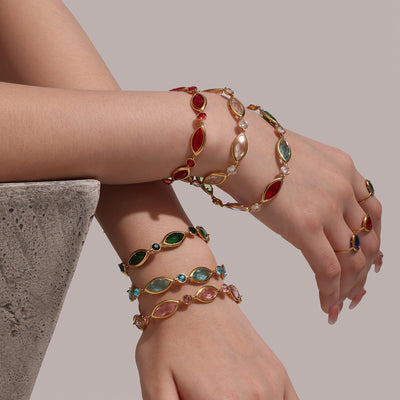 Arms stacked with multicolor marquise Czech glass gold bracelets