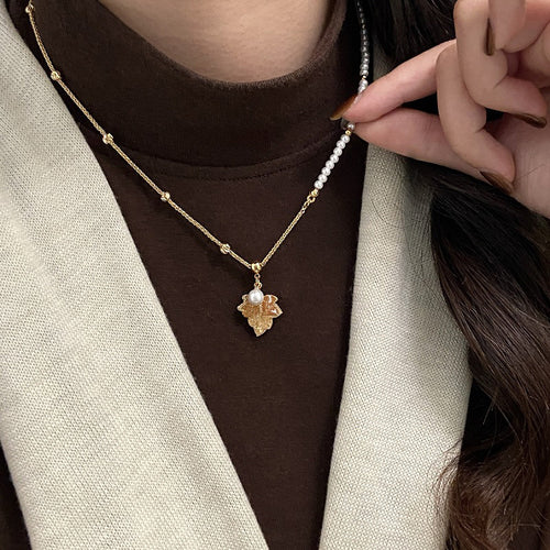 Product image 1 showing a white pearl strand with a small gold tone maple leaf pendant