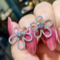Silver Tone Four Petal Floral Stud Earrings with Clear Stones view 3