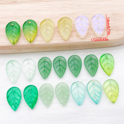 Translucent glass leaf charms in green finishes arranged as a full product overview