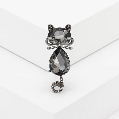 Green crystal cat brooch close-up on white blocks