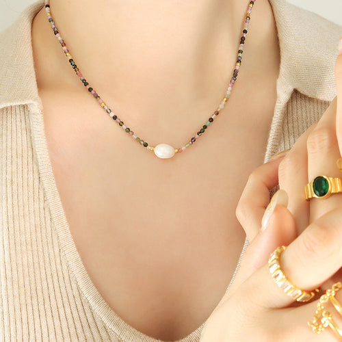 Multicolor stone bead pearl necklace worn on beige top
