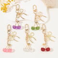 Glitter Resin Cherry Keychain with Gold-Tone Bow and Lobster Clasp view 1