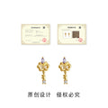 Gold Tone Iris Key Shape Purple And Clear Stone Stud Earrings view 3
