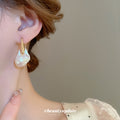 Gold Tone Organic Pearl Drop Earrings With Sculpted Top Detail view 4