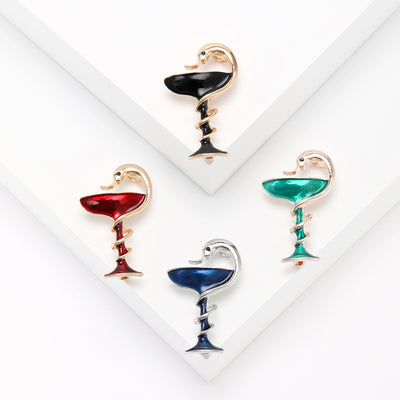snake coiled around a goblet brooch shown from the front